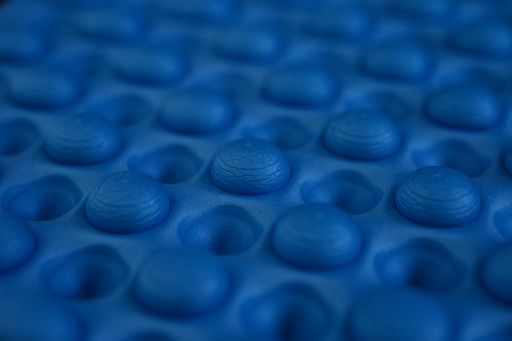 A closeup shot of details of a blue fitness mat