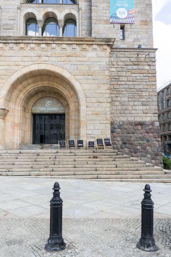 A row of metal poles in front of the Imperial castle building entrance