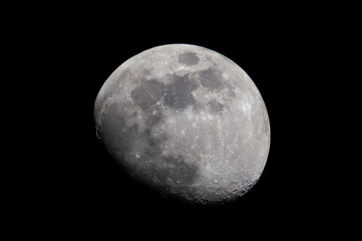 A detailed image of the moon's surface with craters visible against a dark sky