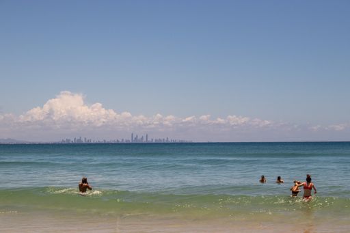 People bathing in the Pacific Ocean. Byron Bay, Australia. In the horizon, Surfer's Paradise.