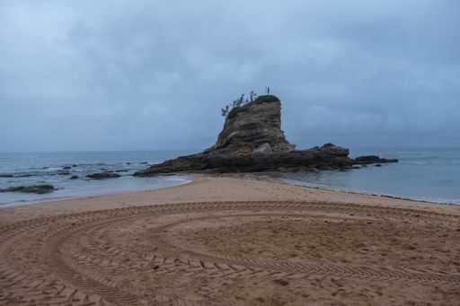 A scenic view of rock statue in Playa del Camello at Santander, Spain