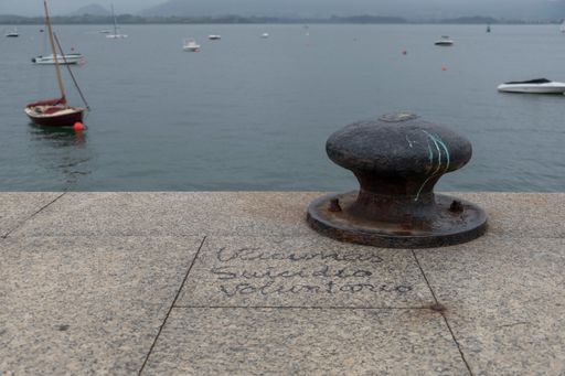 An old rusty bollard on a pier by the sea