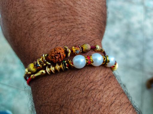 A closeup of a bracelet on a wrist of a man