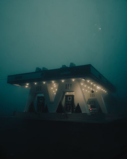 A blurry shot of a gas station with fog in the background