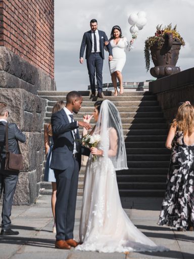 A vertical shot of bride and groom in front of the tower staircase in Stockholm, Sweden