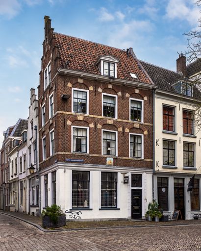 A charming European street with historic brick buildings in the background