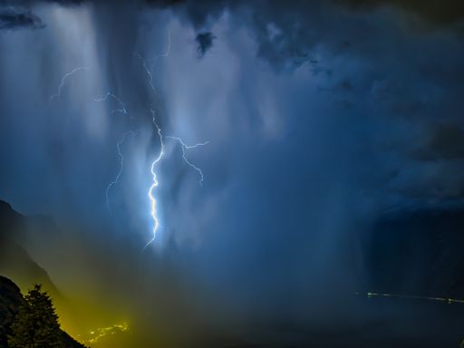 A lightning bolt in a night sky on Lake Garda in Italy with beautiful clouds