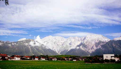 A landscape of house village with snow-capped mountains background