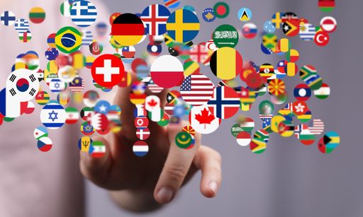 A 3d rendering of national flags in the global communication, messaging, and translation concept with a hand reaching