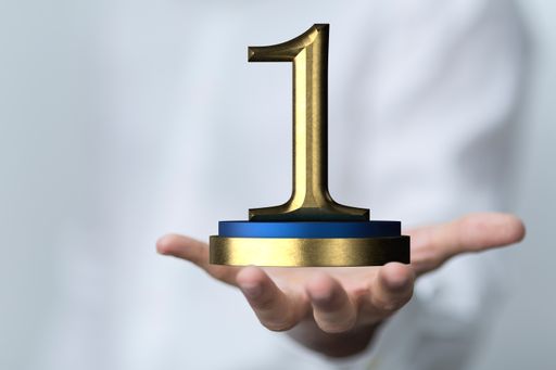 A 3D rendered number 1 presented to a businessman for one year or first place digital award