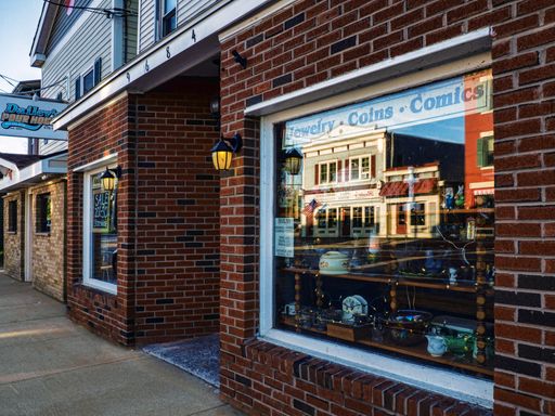 Brewerton, New York, USA. August 22,2021 .The small rural village of Brewerton, New York with store fronts and reflection on a quiet weekend morning