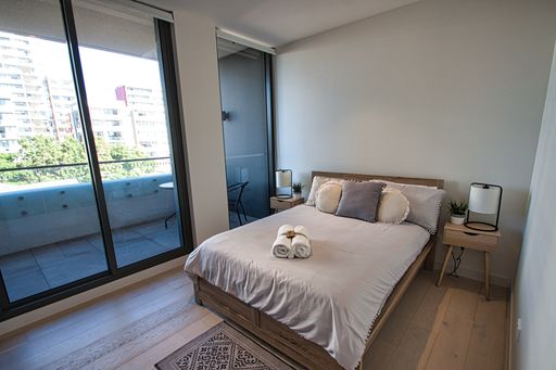 A beautiful shot of a bedroom in a residential house in Sydney, Australia, with a queen-sized bed
