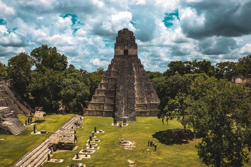 Stunning view of an ancient Maya temple in Tikal, Guatemala, surrounded by lush jungle and showcasing the grandeur of the lost civilization.
