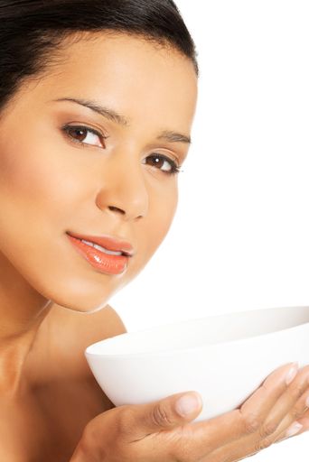 A close up shot of a Caucasian women holding a white skincare bowl