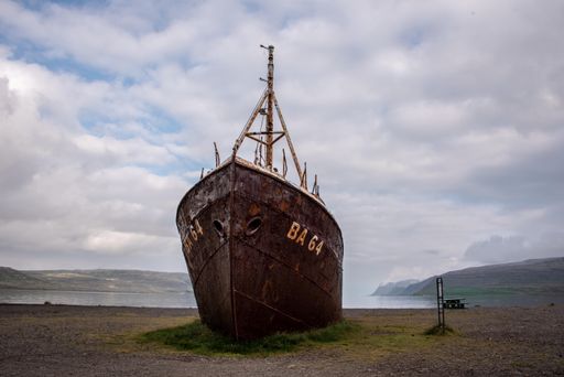 The old rusty ghost ship moored on the land. Iceland.