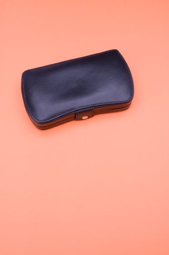 closed manicure set bag with copy space at the bottom orange background