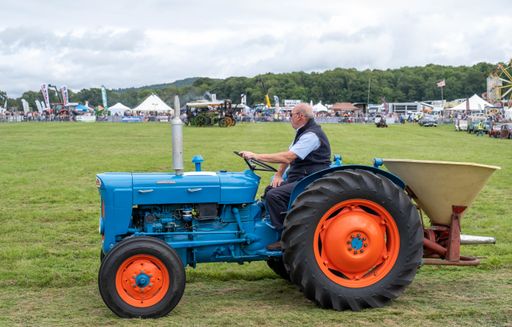 A blue tractor with orange wheels at the Gillingham and Shaftesbury Show
