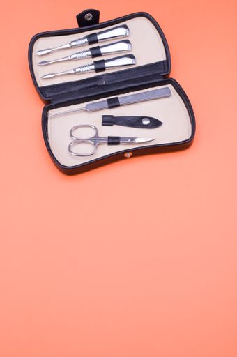 Manicure set bag with copy space at the bottom orange background