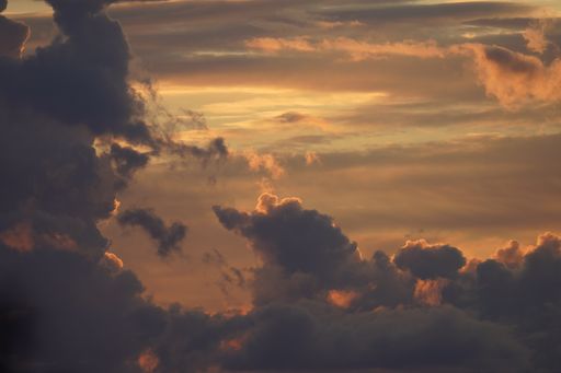 A view of dramatic fluffy cloudscape at sunset
