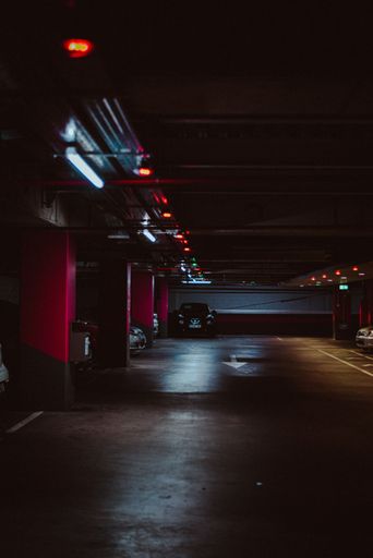 A vertical shot of an underground vibe in a subterranean garage at night