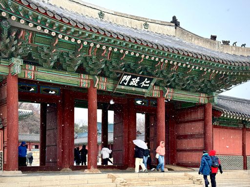 Visitors walk through the historic gates of Changdeokgung Palace in Seoul, South Korea.
