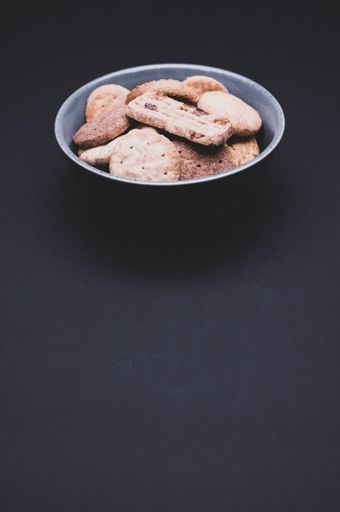 A vertical shot of biscuits on a dark background with copy space