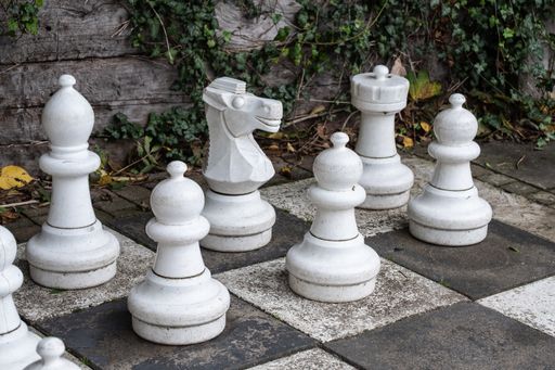 A closeup of the street white chess pieces.