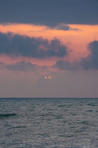 A dramatic sunset sky over the calm sea