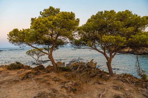 The sunset over the sea captured from the beach of Platja De S'arenella in Cadaques, Spain