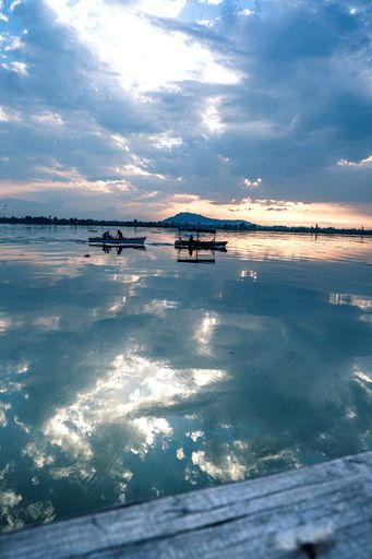 A vertical shot of boats in the beautiful Dal Lake at the sunset in Srinagar, J&k, India