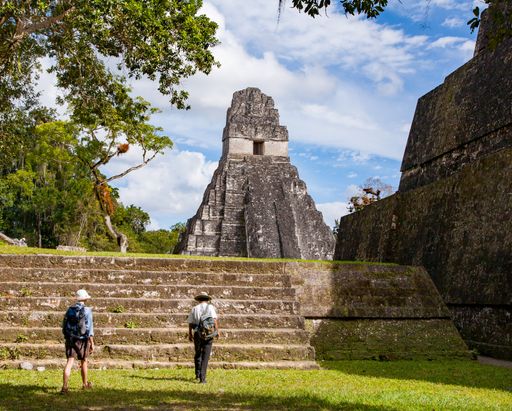 The tourists moving towards the Temple of the Jaguar in the city of Tikal in Guatemala