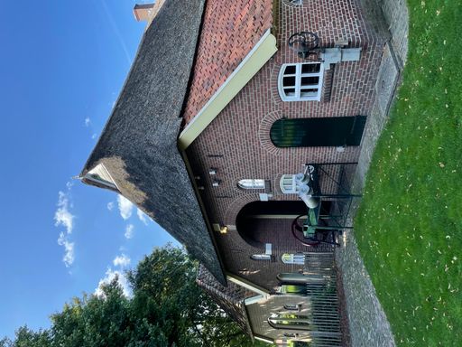 A vertical shot of a beautiful brick building under a clear blue sky
