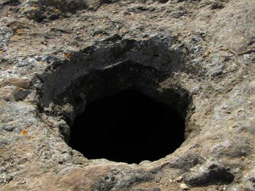 A closeup shot of a hole dug through the ground from the Bronze Age in Maltese Islands, Malta