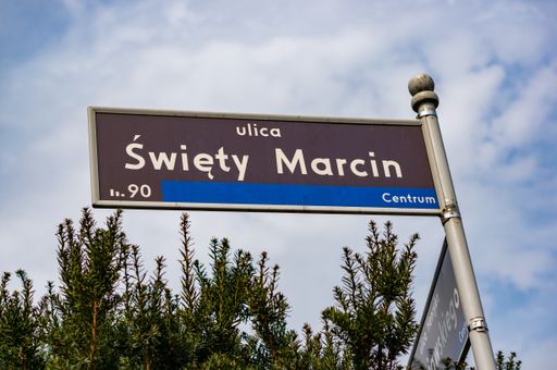 A low angle shot of Swiety Marcin street name sign under a cloudy sky in Poznan, Poland