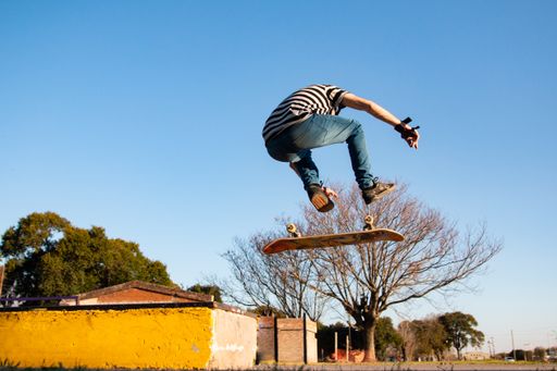The young man doing a flip on the skateboard.