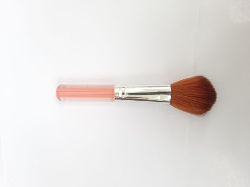 A top view of a single pink makeup brush isolated on a white background