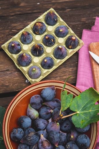 The Purple black figs on a rustic wooden table