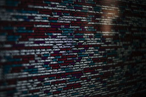 A closeup shot of a screen with HTML JavaScript source code for web page development data