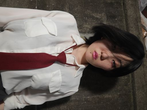A flipped vertical shot of a young serious South Asian lady wearing a school uniform
