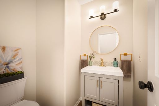A bathroom scene with neutral tones, modern decor, soft lighting, and nice furnishings