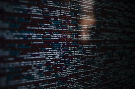 A closeup shot of a screen with HTML JavaScript source code for web page development data