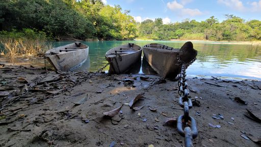 A peaceful view of the kayaks on the chore of a lake in a beautiful forest in Chiapas, Mexico