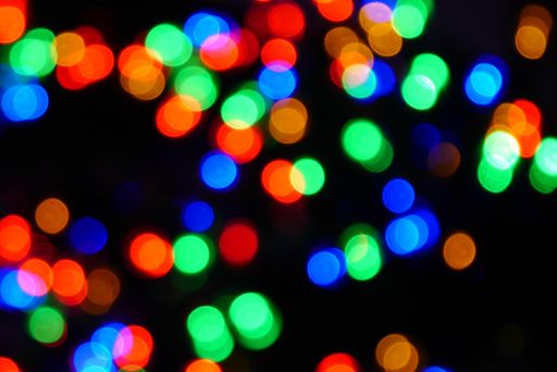 A closeup shot of colorful lights in circle shapes on a black background