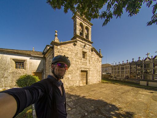 A caucasian male selfie with camera on forehead by Miraz church on santiago de compostela Pilgrimage