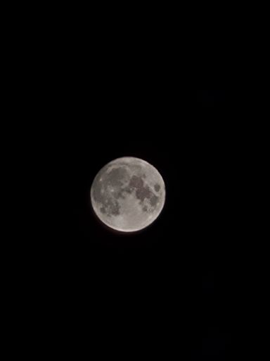 A full moon in the dark black sky