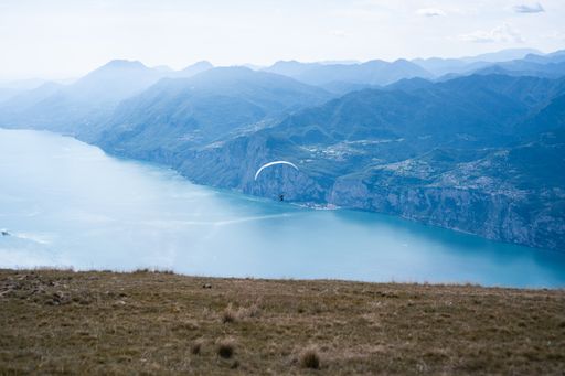A parachute flying over the Garda lake in North Italy