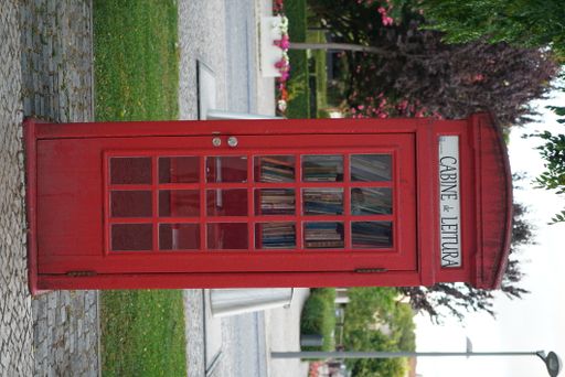 A vertical shot of a red reading booth outdoors