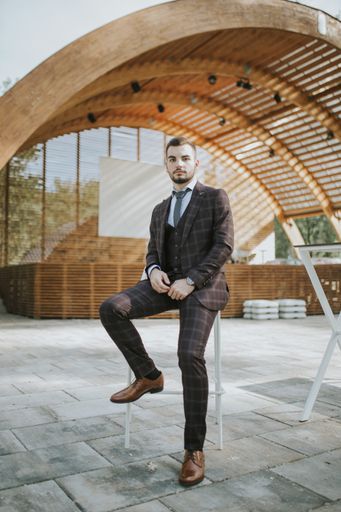 A handsome elegantly dressed Caucasian man posing outdoors