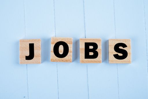 A high angle shot of wooden blocks with JOBS text on a table