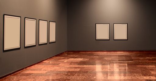 An indoor shot of an exhibition hall with empty frames on the walls